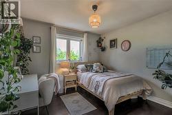 Bedroom featuring wood finished floors and baseboards - 