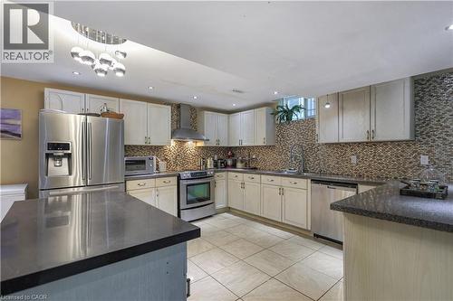 Kitchen with stainless steel appliances, light tile patterned floors, recessed lighting, and dark stone countertops - 254 Rymal Road W, Hamilton, ON - Indoor Photo Showing Kitchen With Upgraded Kitchen