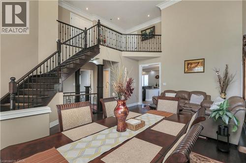 Dining area with a high ceiling, crown molding, and dark wood-style flooring - 254 Rymal Road W, Hamilton, ON - Indoor