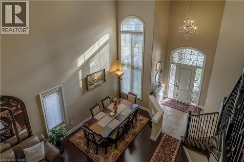 Entrance foyer featuring hanging lights, stone tile floors, and a high ceiling - 254 Rymal Road W, Hamilton, ON - Indoor Photo Showing Other Room With Fireplace