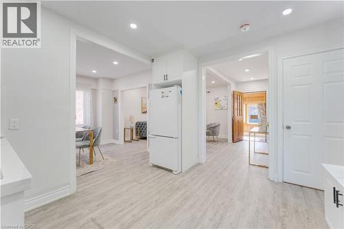 Kitchen with white cabinets, freestanding refrigerator, light wood-style flooring, and recessed lighting - 24 Onward Avenue, Kitchener, ON - Indoor Photo Showing Other Room