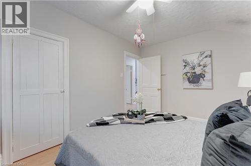 Bedroom featuring light wood finished floors, ceiling fan, and a textured ceiling - 24 Onward Avenue, Kitchener, ON - Indoor Photo Showing Bedroom