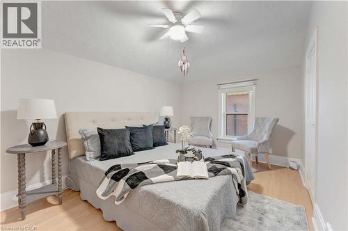 Bedroom featuring light wood-style floors, ceiling fan, and a textured ceiling - 24 Onward Avenue, Kitchener, ON - Indoor Photo Showing Bedroom