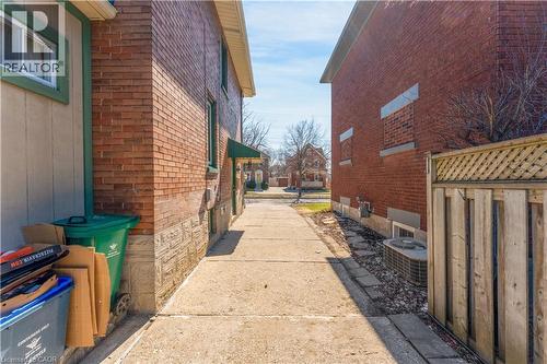 View of home's exterior with brick siding and a central AC unit - 24 Onward Avenue, Kitchener, ON - Outdoor With Exterior
