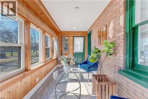 Sunroom with wood finished floors, wood walls, brick wall, and crown molding - 24 Onward Avenue, Kitchener, ON -  Photo Showing Other Room