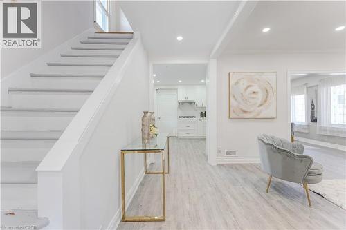 Stairway featuring wood finished floors, recessed lighting, and crown molding - 24 Onward Avenue, Kitchener, ON - Indoor Photo Showing Other Room