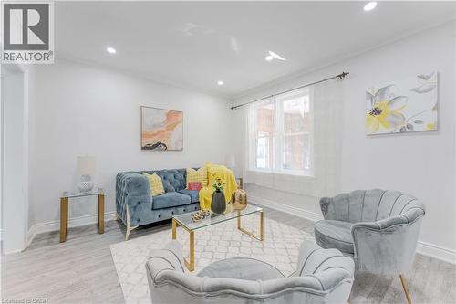 Living room featuring ornamental molding, recessed lighting, and light wood-type flooring - 24 Onward Avenue, Kitchener, ON - Indoor Photo Showing Living Room