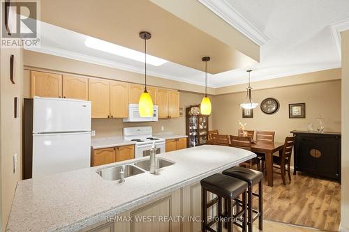 407 - 24 Chapel Street, Halton Hills, ON - Indoor Photo Showing Kitchen With Double Sink