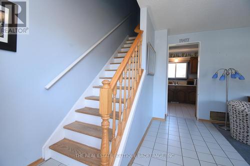Hardwood staircase and tile flooring in hall - 1345 Colonsay Drive, Burlington, ON 