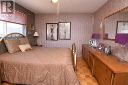 Primary Bedroom featuring parquet flooring - 