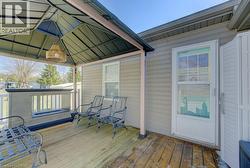Wooden terrace featuring a gazebo - 