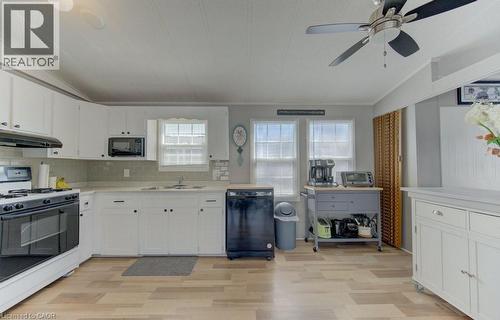 Kitchen featuring black appliances, white cabinets, light countertops, lofted ceiling, and a ceiling fan - 580 Beaver Creek Road Unit# 185, Waterloo, ON - Indoor Photo Showing Kitchen