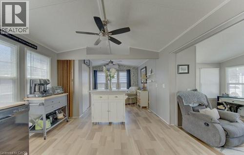 Kitchen with black dishwasher, open floor plan, light countertops, white cabinets, and light wood-style floors - 580 Beaver Creek Road Unit# 185, Waterloo, ON - Indoor
