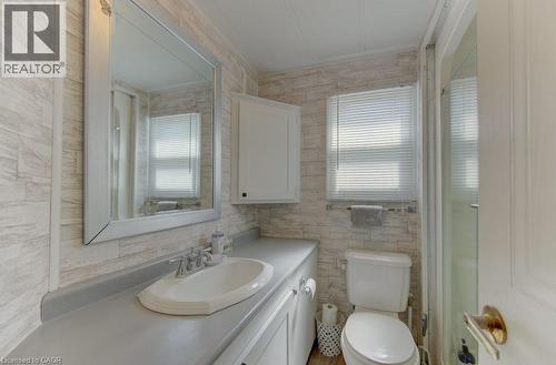 Bathroom with vanity, an enclosed shower, and tile walls - 580 Beaver Creek Road Unit# 185, Waterloo, ON - Indoor Photo Showing Bathroom