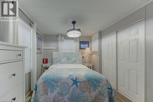 Bedroom with a closet and wood finished floors - 580 Beaver Creek Road Unit# 185, Waterloo, ON - Indoor Photo Showing Bedroom