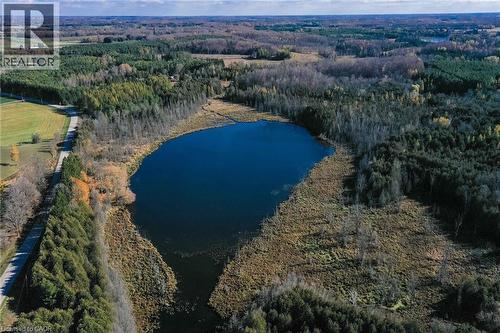 View of property location with a large body of water and a heavily wooded area - 6361 16Th Line, Minto, ON - Outdoor With Body Of Water With View
