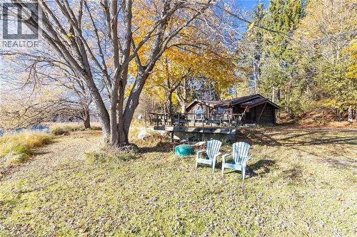 View of green lawn featuring a wooden deck - 6361 16Th Line, Minto, ON - Outdoor