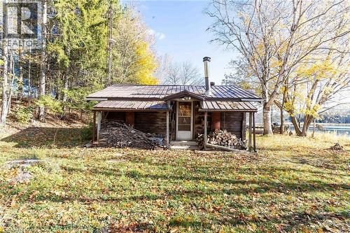 Back of property featuring a lawn and a metal roof - 6361 16Th Line, Minto, ON - Outdoor
