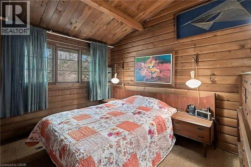 Bedroom with wood ceiling, wood walls, and rustic walls - 6361 16Th Line, Minto, ON - Indoor Photo Showing Bedroom