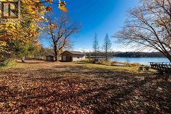 View of yard featuring a water view and an outdoor structure - 