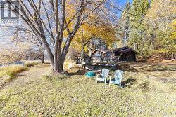 View of green lawn featuring a wooden deck - 