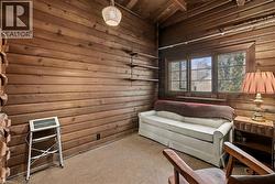 Living area with vaulted ceiling, wooden ceiling, and carpet - 