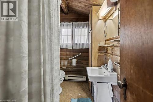 Bathroom with lofted ceiling, a baseboard radiator, and wood walls - 6361 16Th Line, Minto, ON - Indoor Photo Showing Bathroom