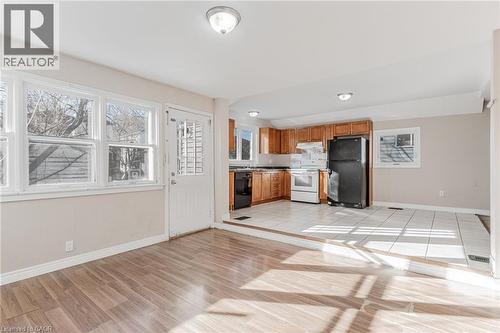 Kitchen featuring black appliances, wood finish cabinets, plenty of natural light, and light wood finished floors - 20 East 27Th Street, Hamilton, ON - Indoor