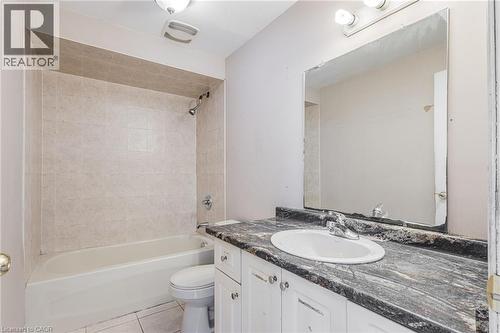 Full bath featuring vanity, light tile patterned floors, and shower / bathtub combination - 20 East 27Th Street, Hamilton, ON - Indoor Photo Showing Bathroom