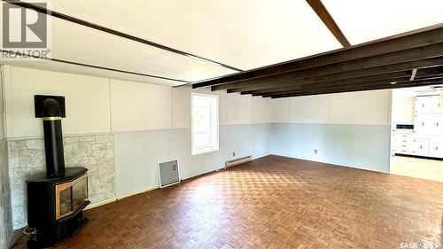 209 1St Street E, Dinsmore, SK - Indoor Photo Showing Other Room With Fireplace