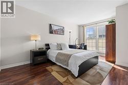 Bedroom featuring baseboards and wood finished floors - 