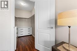Walk in closet with dark wood finished floors - 