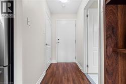 Doorway featuring a textured ceiling and wood finished floors - 