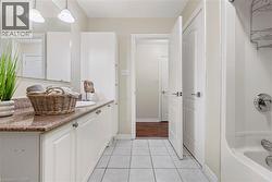 Bathroom featuring vanity, light tile patterned floors, and bathing tub / shower combination - 