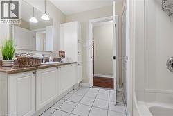 Bathroom featuring vanity and light tile patterned floors - 