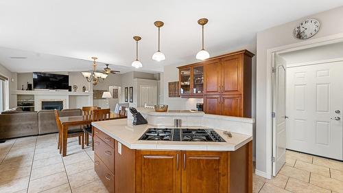 5190 Cobble Crescent, Kelowna, BC - Indoor Photo Showing Kitchen With Fireplace