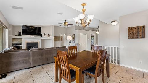5190 Cobble Crescent, Kelowna, BC - Indoor Photo Showing Dining Room With Fireplace