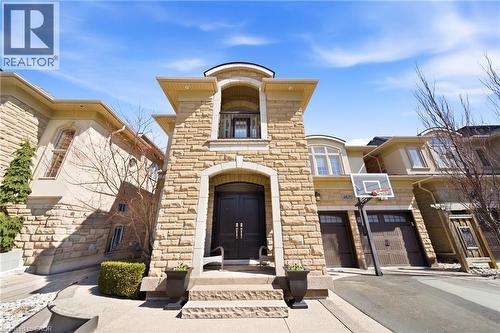 View of building exterior with driveway and a garage - 4670 Bracknell Road, Burlington, ON - Outdoor With Facade