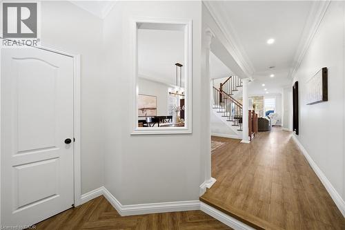 Corridor with parquet flooring, crown molding, and suspended lighting - 4670 Bracknell Road, Burlington, ON - Indoor Photo Showing Other Room