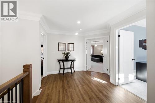 Hallway with wood finished floors and crown molding - 4670 Bracknell Road, Burlington, ON - Indoor Photo Showing Other Room