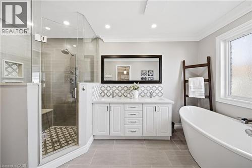 Bathroom featuring a freestanding bath, a shower stall, double vanity, recessed lighting, and ornamental molding - 4670 Bracknell Road, Burlington, ON - Indoor Photo Showing Bathroom