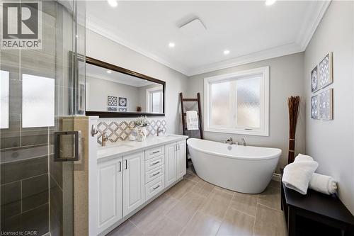 Bathroom with a shower stall, double vanity, crown molding, a soaking tub, and light tile patterned floors - 4670 Bracknell Road, Burlington, ON - Indoor Photo Showing Bathroom