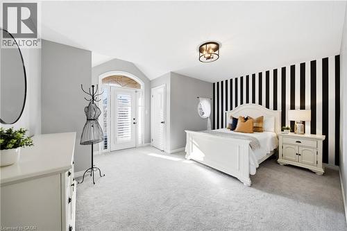 Bedroom featuring an accent wall, light carpet, and wallpapered walls - 4670 Bracknell Road, Burlington, ON - Indoor Photo Showing Bedroom