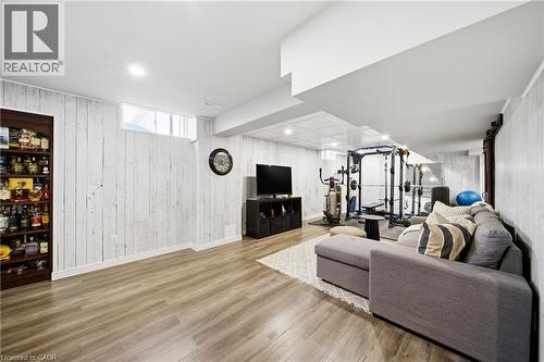 Living room featuring wooden walls, wood finished floors, and recessed lighting - 4670 Bracknell Road, Burlington, ON - Indoor