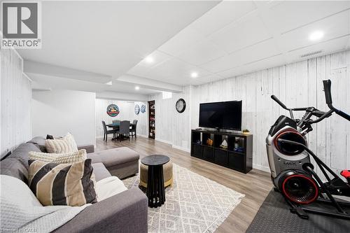 Living area with wood walls, light wood-type flooring, and recessed lighting - 4670 Bracknell Road, Burlington, ON - Indoor