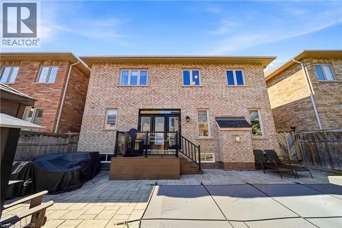 Back of property featuring brick siding, a patio, and french doors - 4670 Bracknell Road, Burlington, ON - Outdoor With Deck Patio Veranda With Exterior