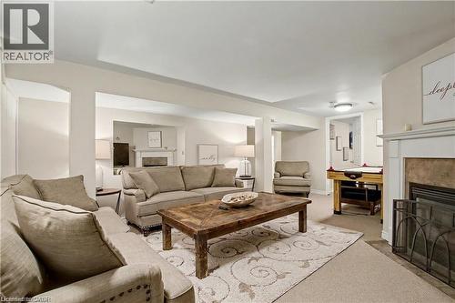 Living area featuring a premium fireplace and carpet floors - 11 Carwyn Crescent, Hamilton, ON - Indoor Photo Showing Living Room With Fireplace