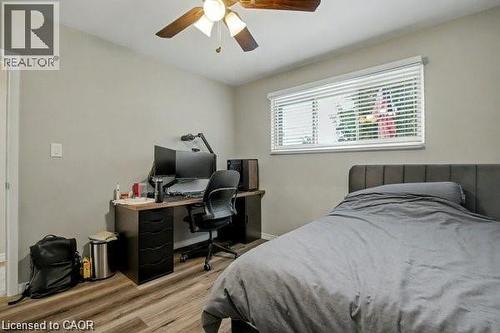Bedroom featuring a desk, wood finished floors, and a ceiling fan - 11 Carwyn Crescent, Hamilton, ON - Indoor Photo Showing Bedroom