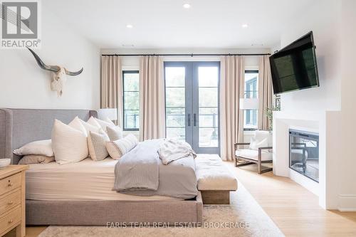 4 Sycamore Circle, Springwater, ON - Indoor Photo Showing Bedroom With Fireplace