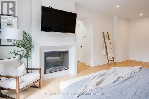 4 Sycamore Circle, Springwater, ON - Indoor Photo Showing Bedroom With Fireplace
